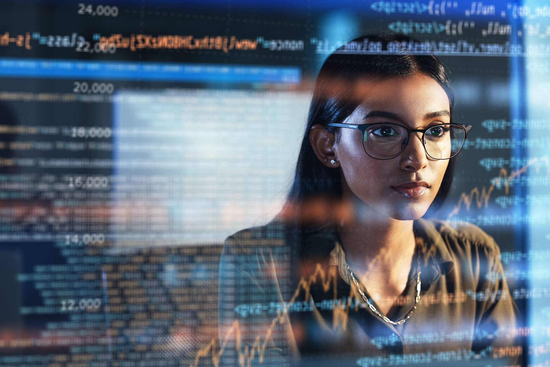 A woman who specializes in AI applied to the financial sector, analyzing code.